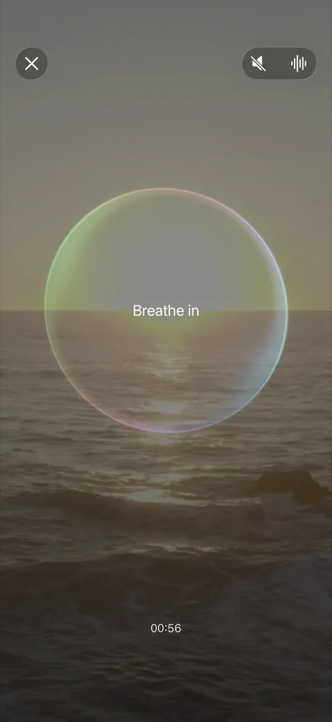 Block It! guided breathing with a glass circle over a quiet shoreline